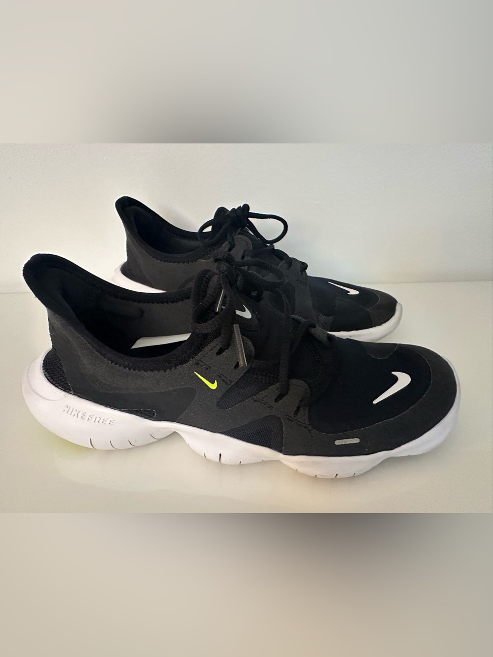 Nike Free Black Athletic Sneakers with White Sole and Green Swoosh